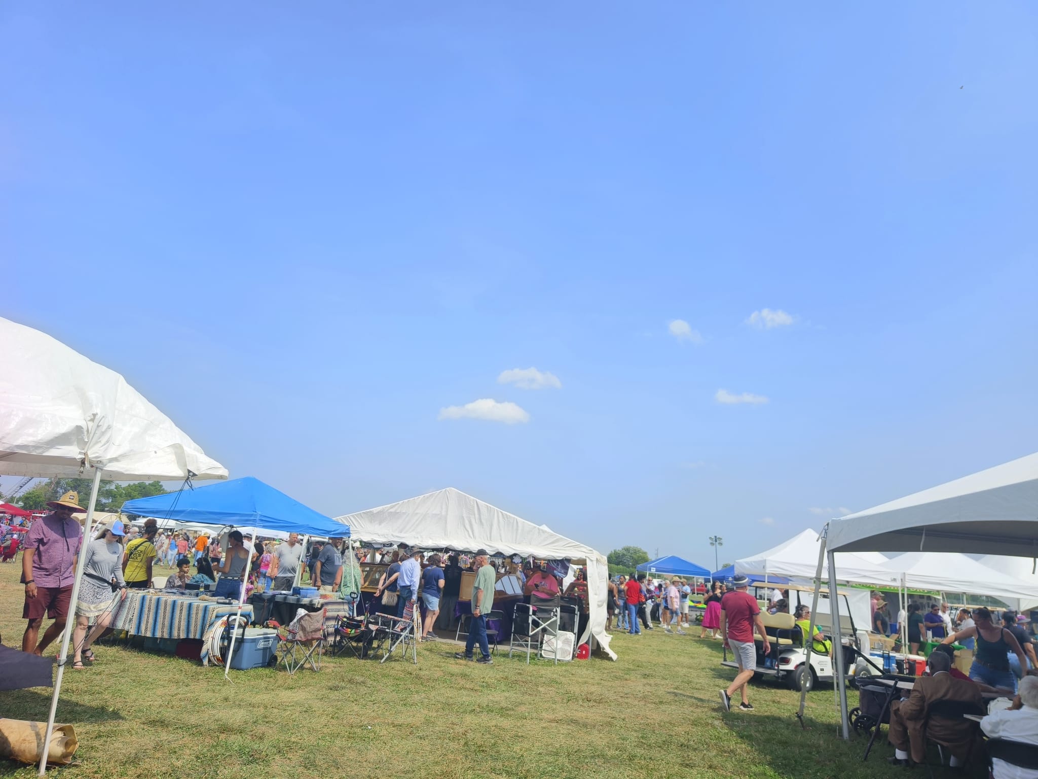PowWow grounds — vendor tents, food trucks, and hundreds of visitors