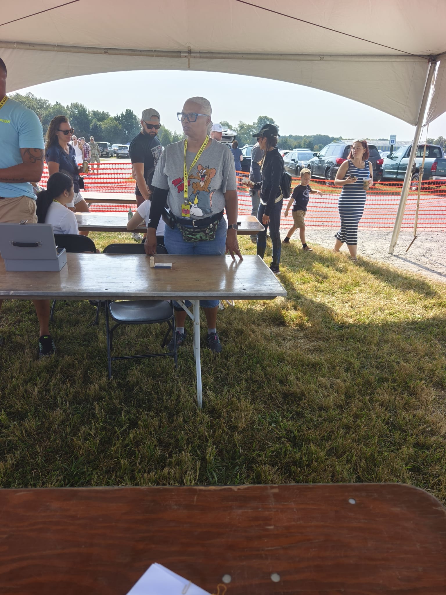 Colorful vendor booth with bracelets, dreamcatchers, hats, and handmade figurines